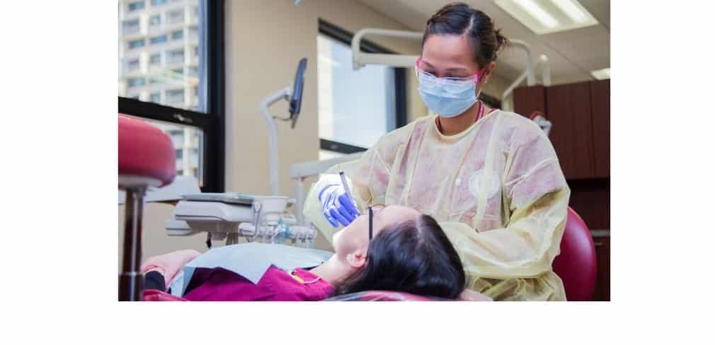 Dental Hygienist Cleans A Patient’s Teeth